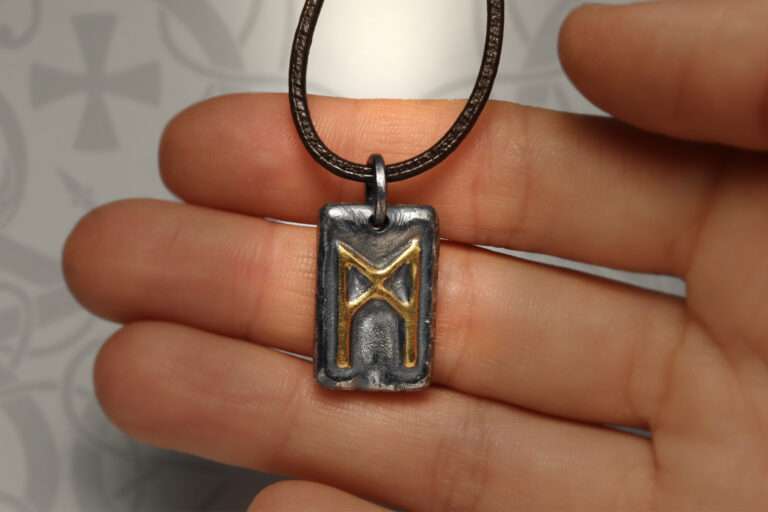 mannaz viking rune pendant on hand