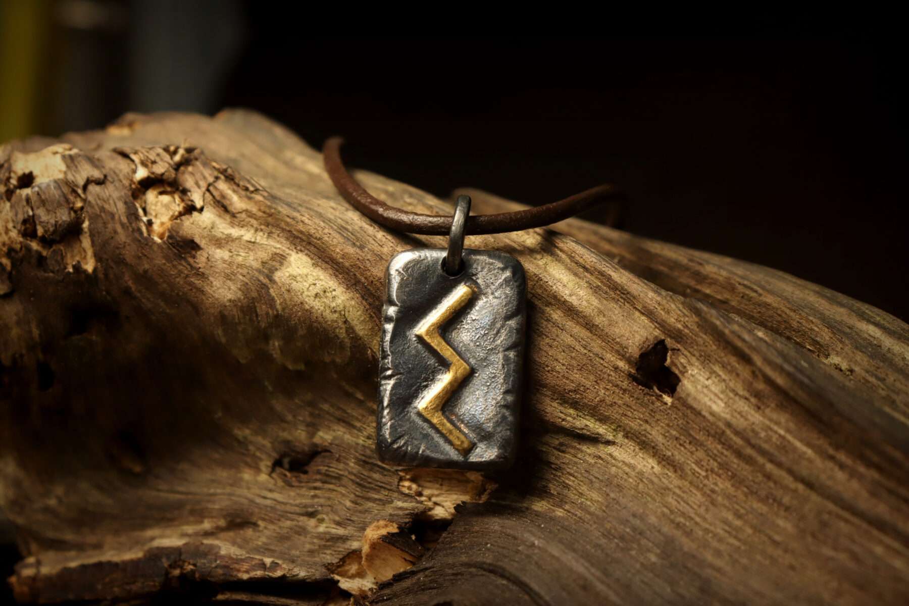 sowilo viking rune pendant on wood