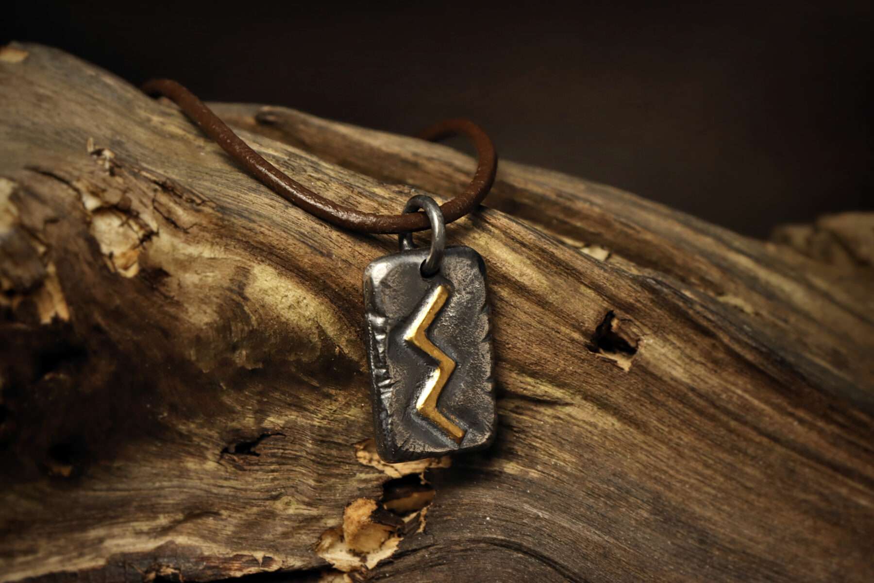 sowilo viking rune pendant on wood